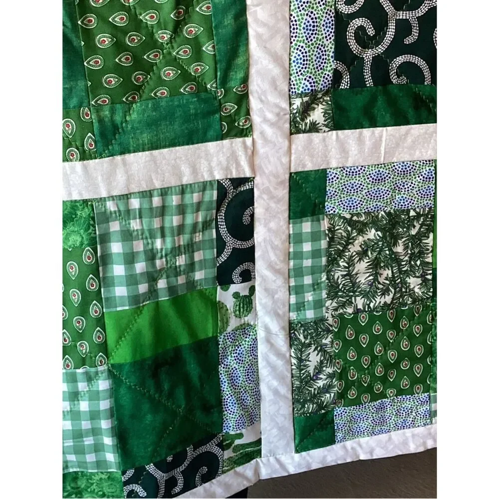 New without tags. Medley of Green Fabrics with White Borders Quilt